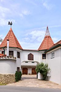 a large white house with two towers at Apartment im Schlössl in Leibnitz