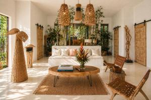 a living room with a white couch and a table at Tides Signature Koh Chang in Ko Chang