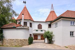 a large white house with two towers at Apartment im Schlössl in Leibnitz
