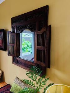 a mirror hanging on a wall with a window at Eagles Nest in Kirstenhof