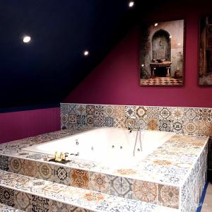 a large bath tub in a room with purple walls at St Hildas Boutique in Hinderwell