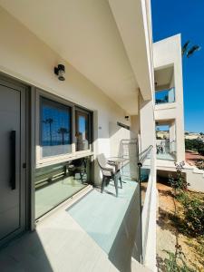 a balcony of a house with a table and chairs at Saradari Beach Hotel - Adults Only in Hersonissos +53 photos