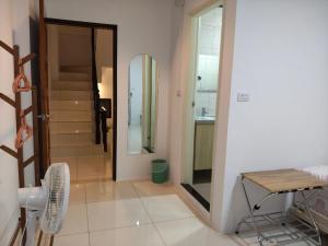 a hallway with a table and chairs and a bathroom at Daiwen Homestay in Jiaoxi +48 photos