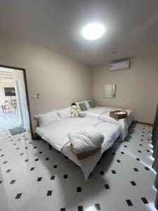 a bedroom with two beds with a teddy bear on it at P2 Location pool villa in Ban Pak Chong +68 photos