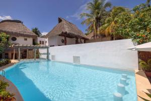 a swimming pool in front of a villa at Villas HM Paraiso del Mar in Holbox Island