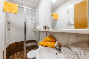 a bathroom with a sink and a toilet and a shower at Appartement Lackner TOP 2 - Weissensee in Weissensee +58 photos