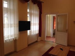 a living room with a flat screen tv on the wall at Péterfia Apartman in Debrecen