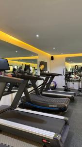 a gym with a row of treadmills at Roseann Gold Boutique Hotel in Kusafe