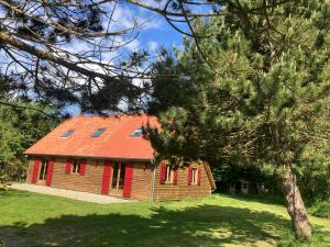 an old house with a red roof and some trees at La petite maison sur la colline in Rue
