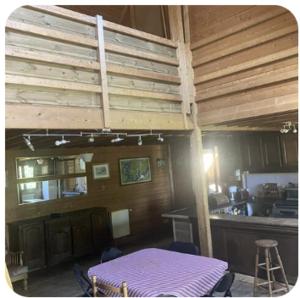 a room with a purple bed in the middle of a kitchen at La petite maison sur la colline in Rue +6 photos