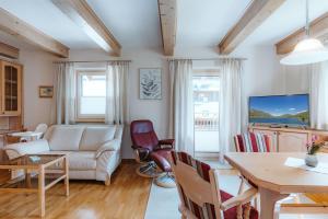 a living room with a couch and a table at Appartement Lackner TOP 2 - Weissensee in Weissensee