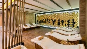 ein Restaurant mit weißen Tischen und einer goldenen Wand in der Unterkunft B Business Hotel & Spa in Antalya