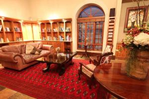a living room with a couch and a table at La Villa Vita Boutique Hotel & Spa in Nelspruit