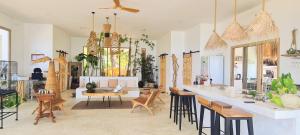 a living room with a bar and a table and chairs at Tides Signature Koh Chang in Ko Chang