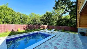 a swimming pool in the backyard of a house at Qafqaz A-Frame Chalet Gabala in Gabala +15 photos