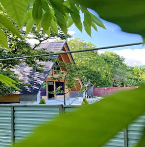 a house with a metal roof on top of it at Qafqaz A-Frame Chalet Gabala in Gabala