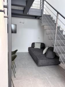 a bedroom with a bed under the stairs at Monica's Loft in Domodossola