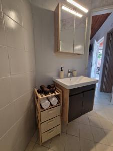 a bathroom with a sink and a mirror at Peter's Village in Kalamaki Messinia +66 photos
