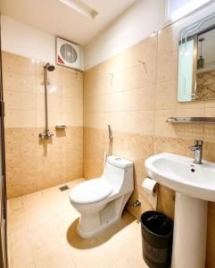 a bathroom with a toilet and a sink at The Eastern Lodge in Islamabad +37 photos