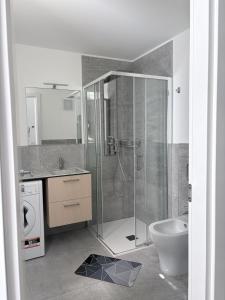 a bathroom with a shower and a toilet and a sink at Monica's Loft in Domodossola +30 photos