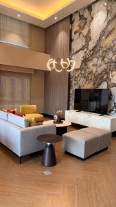 a living room with a couch and a tv at studio MA-DE cozy Bacolod City in Bacolod