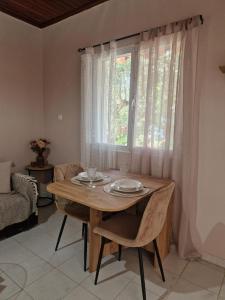 a dining room with a table and a window at Peter's Village in Kalamaki Messinia