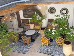 an outdoor patio with a table and chairs and plants at Maison Romy in Chinon