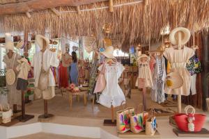 a store with a bunch of dresses and hats on display at Villas HM Paraiso del Mar in Holbox Island +78 photos