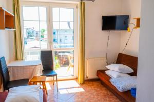 a living room with a couch and a large window at Helena in Karwia