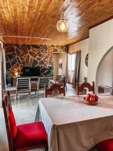a living room with a table and a stone wall at Lekkerbly Self Catering in Pofadder