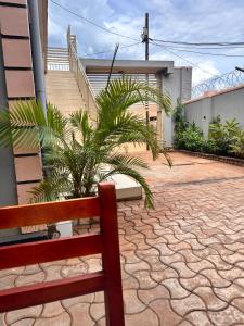 a bench sitting in front of a house with a staircase at Zone hotel and guest house in Bugembe