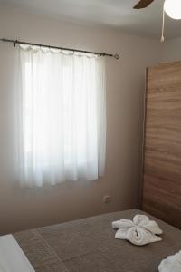 a bedroom with a bed with two towels on it at EUCALYPTUS in Nerezine