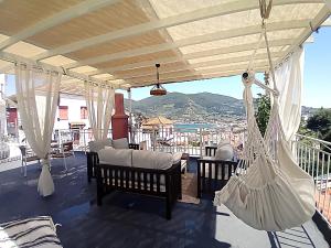 a porch with hammocks and a balcony with a view at Duka's Gardenhouse in Skopelos Town