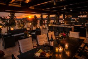 a restaurant with tables and chairs and a bar at Luxury Penthouse with private pool in Preveza