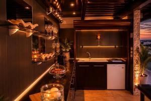 a kitchen with a counter with a sink and a counter at Luxury Penthouse with private pool in Preveza