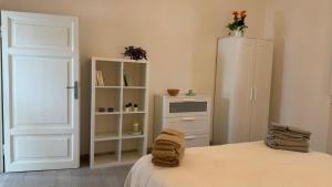 a bedroom with a bed and a white cabinet at La Casa di Katia in Pisa +9 photos