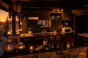 a kitchen with a counter with glasses of wine at Luxury Penthouse with private pool in Preveza