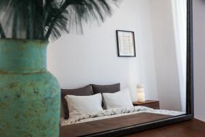a bedroom with a bed and a mirror on a table at House Sao Bento in Lisbon