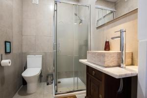 a bathroom with a shower and a toilet and a sink at House Sao Bento in Lisbon