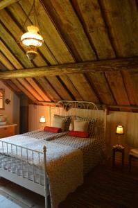 a bedroom with a bed with a wooden ceiling at Ekengård in Köping
