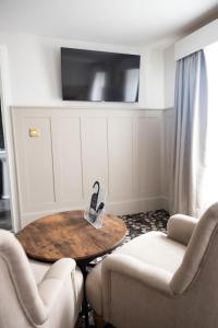 a room with a table and two chairs and a tv at Allerdale Court Hotel in Cockermouth
