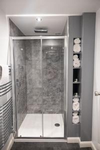 a shower with a glass door in a bathroom at Allerdale Court Hotel in Cockermouth +111 photos