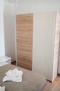 a bedroom with a bed with two towels on it at LAVANDLA in Nerezine