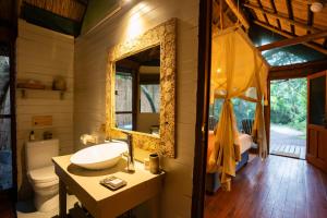 a bathroom with a sink and a mirror at Kosi Forest Lodge in Manguzi +54 photos