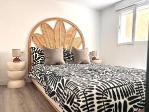 a bedroom with a large bed with a zebra print bedspread at Jazmin 6 ( whole apartment ) in Alicante