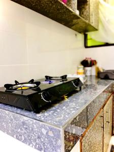 a stove top on a counter in a kitchen at Studio Kilifi -Pendoraha Homes in Kilifi