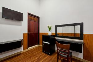 a room with a desk and a mirror and a chair at Grand Center Da Lat by Lilly Hotel in Da Lat +30 photos