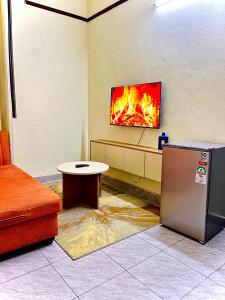 a living room with a fire on the wall at Studio Kilifi -Pendoraha Homes in Kilifi