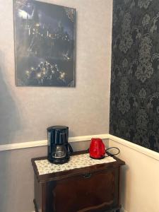 a coffee maker on a table in a room at La chambre magique in Masseret