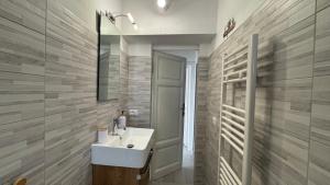 a bathroom with a sink and a mirror at La Casa di Katia in Pisa